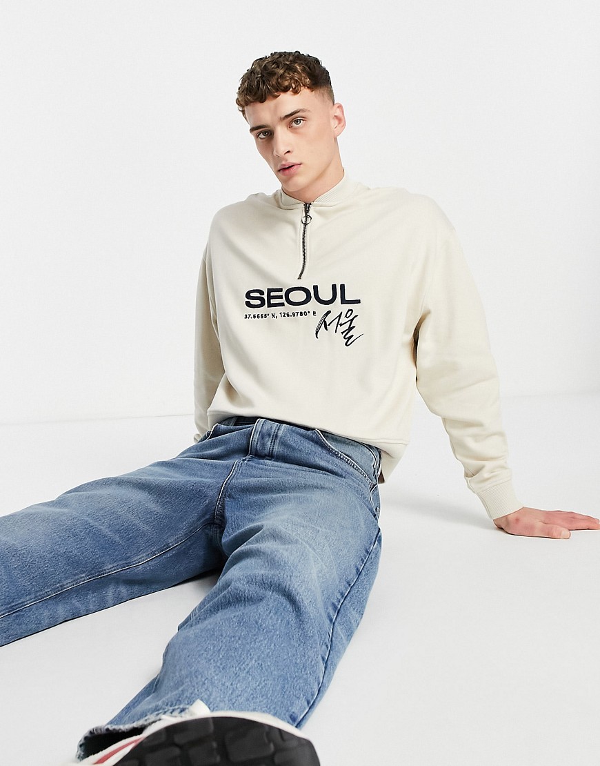 ASOS DESIGN oversized sweatshirt in beige with baseball neck and Seoul chest print-Grey