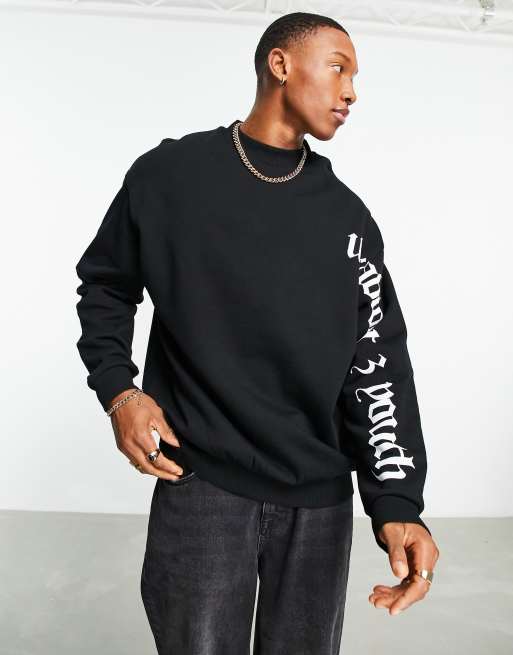 ASOS DESIGN oversized sweatshirt in black with text arm and back