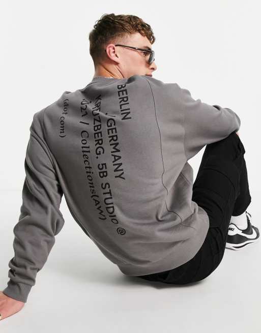 ASOS DESIGN oversized sweatshirt in dark grey with seam details and city prints