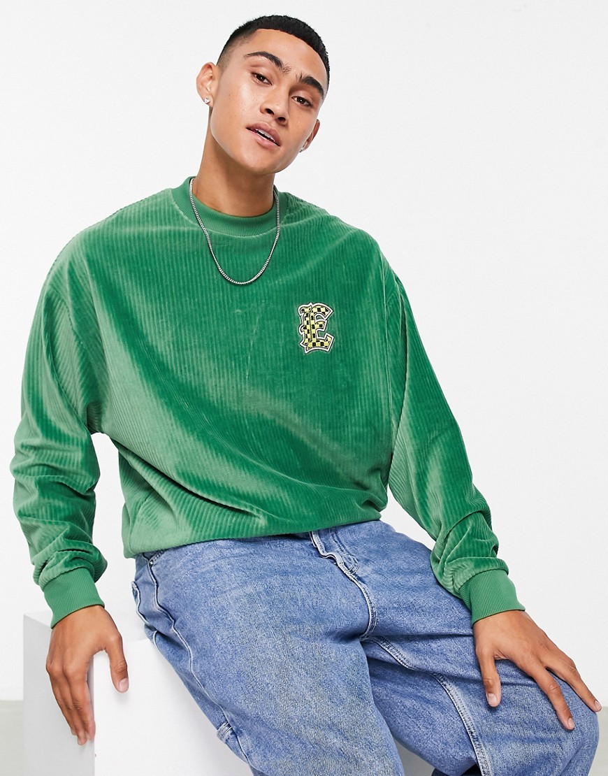 ASOS DESIGN oversized sweatshirt in green ribbed velour with varsity badge