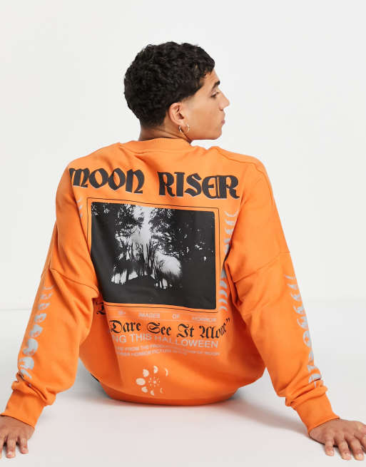 ASOS DESIGN oversized sweatshirt in orange with horror movie poster prints