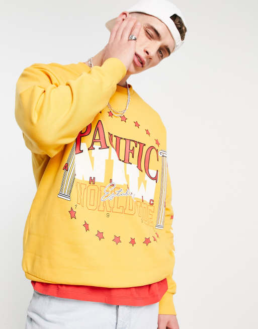 ASOS DESIGN oversized sweatshirt in orange with varsity print