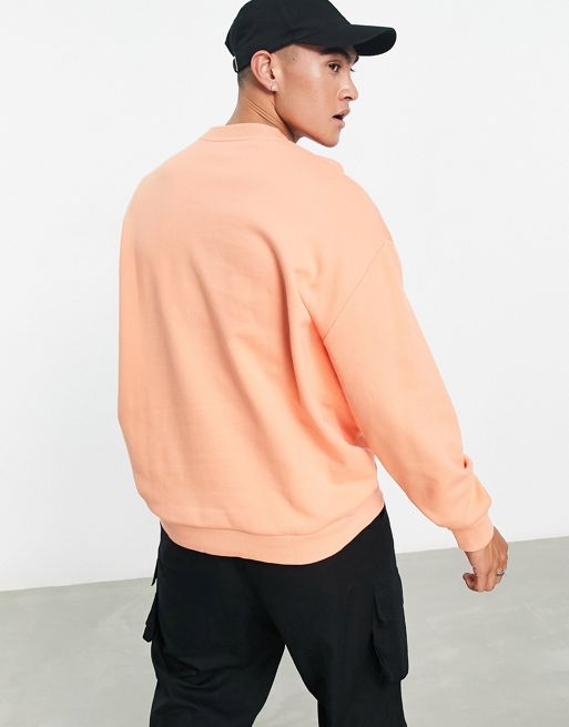 ASOS DESIGN oversized sweatshirt in bright orange