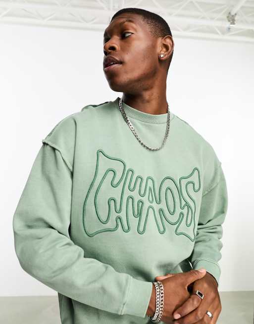 ASOS DESIGN oversized sweatshirt in washed green with chaos