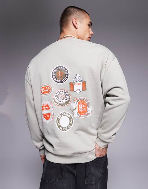 ASOS DESIGN oversized sweatshirt with beer mat prints in gray