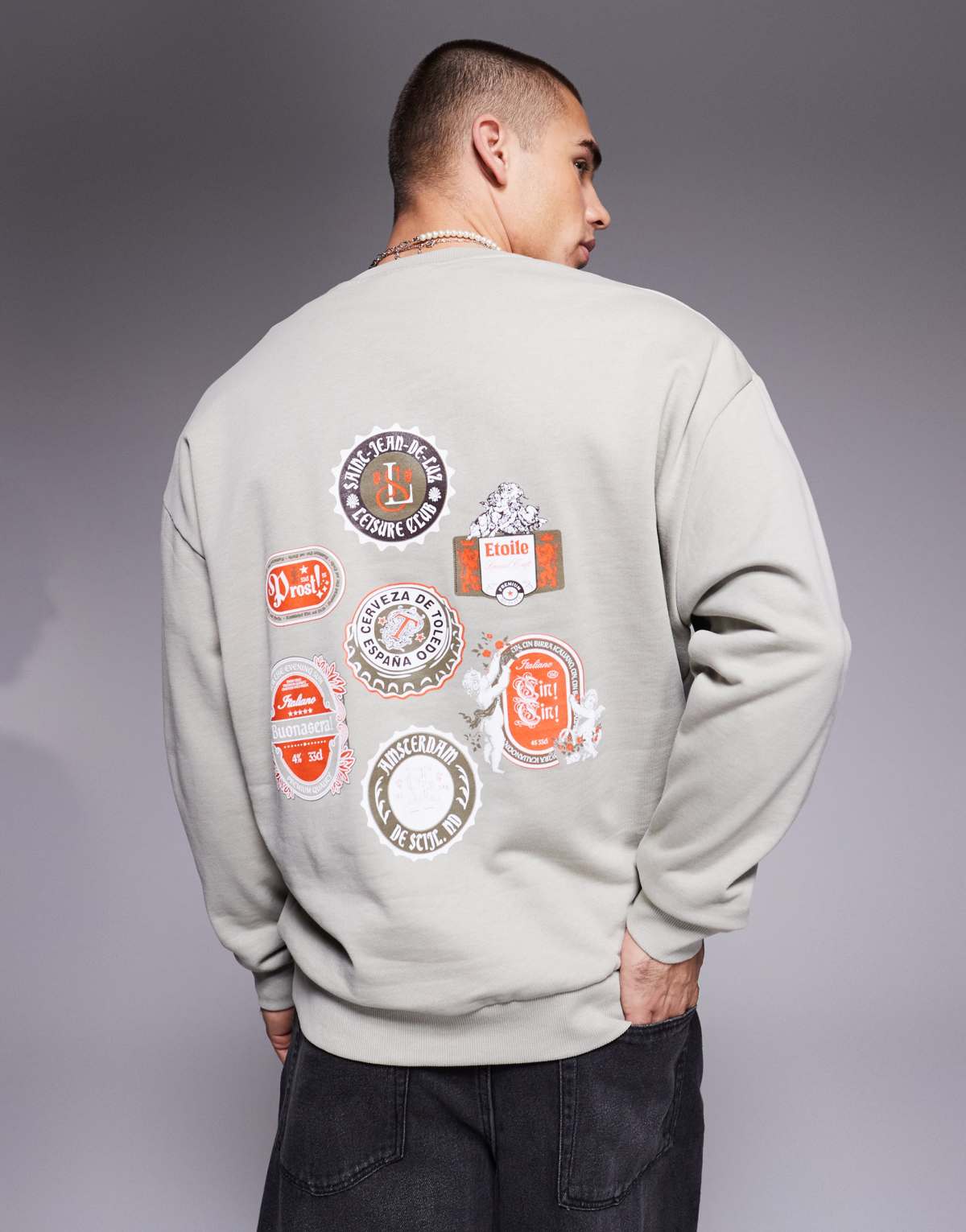 ASOS DESIGN oversized sweatshirt with beer mat prints in grey