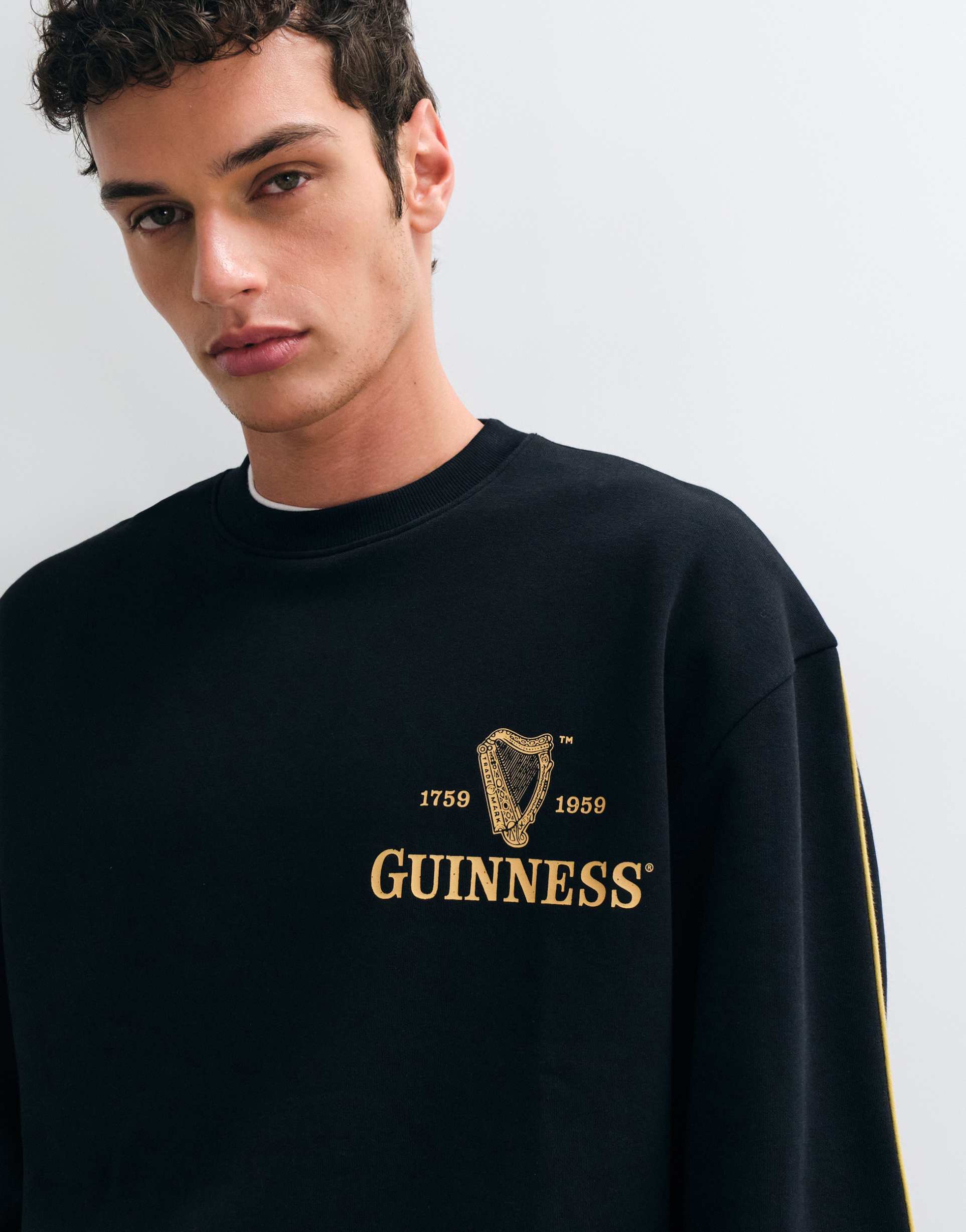 ASOS DESIGN oversized sweatshirt with Guinness in Black