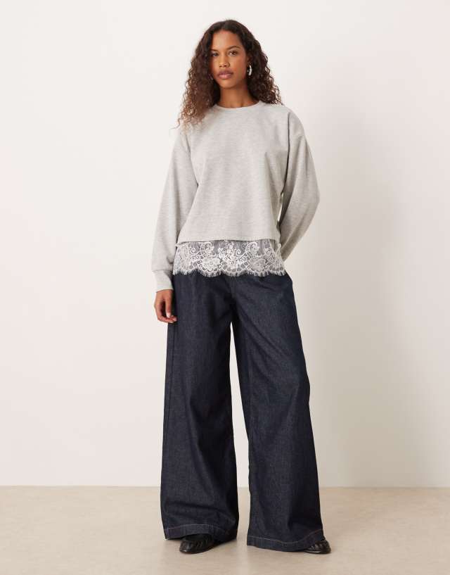 ASOS DESIGN oversized sweatshirt with lace hem underlayer detail