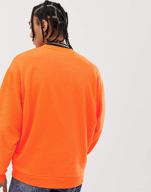 ASOS DESIGN oversized sweatshirt with reverse panel in neon orange