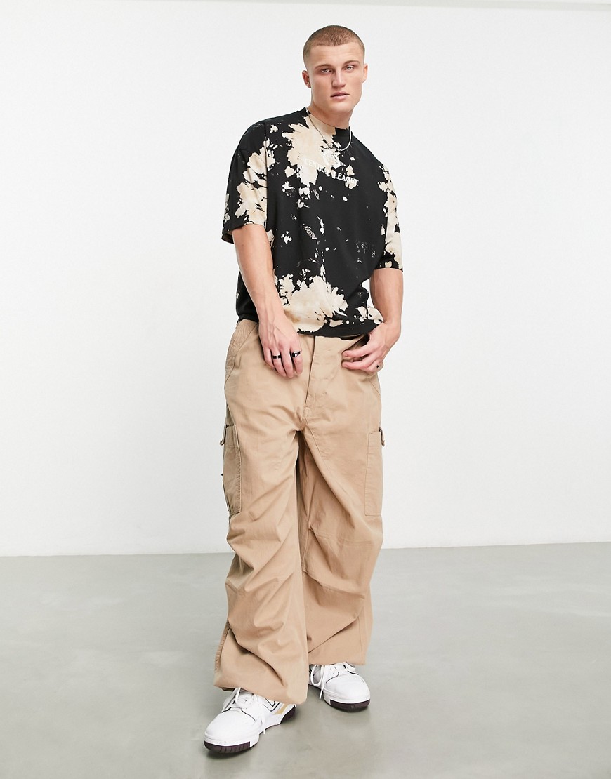ASOS DESIGN oversized T-shirt in black bleach tie dye with chest print