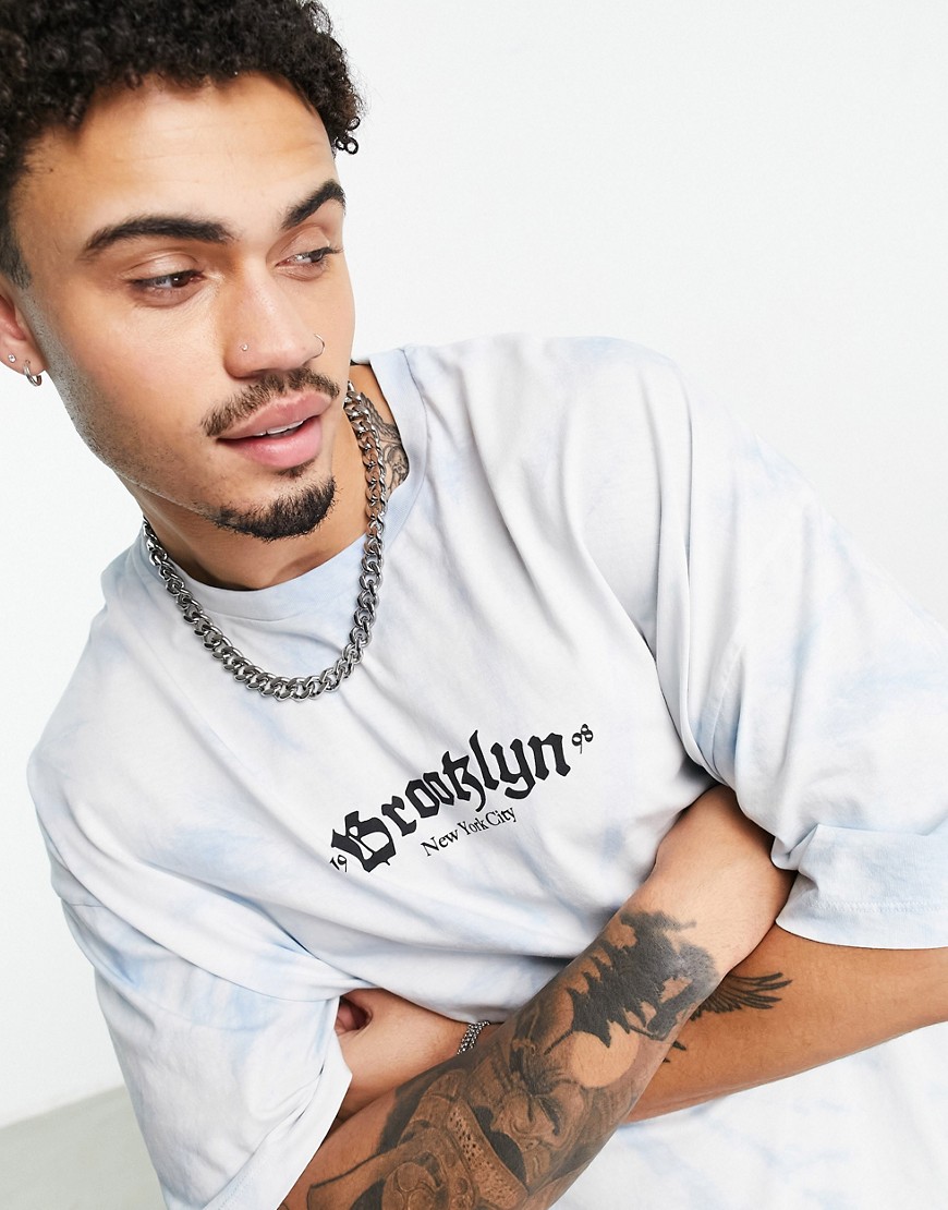ASOS DESIGN oversized t-shirt in blue wash with gothic text chest print