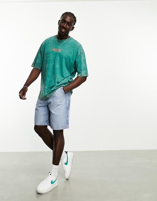 ASOS DESIGN oversized t-shirt in green wash with city chest print