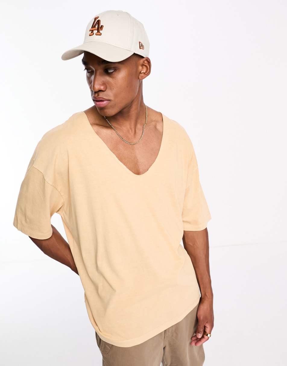 ASOS DESIGN oversized t-shirt in washed yellow with deep V