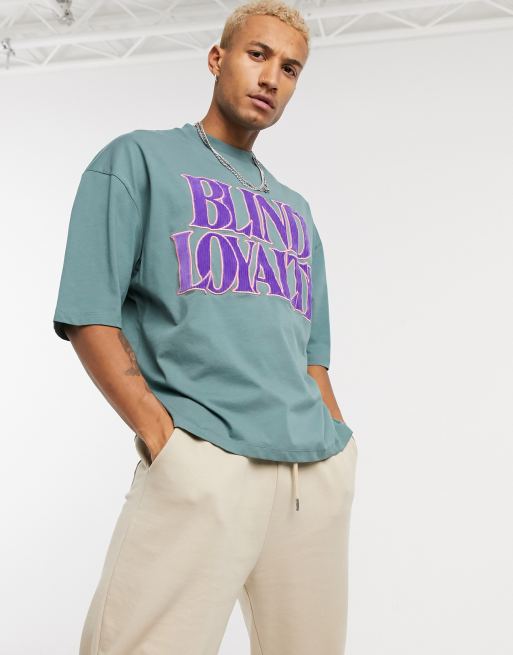ASOS DESIGN oversized t-shirt with corduroy applique text in green