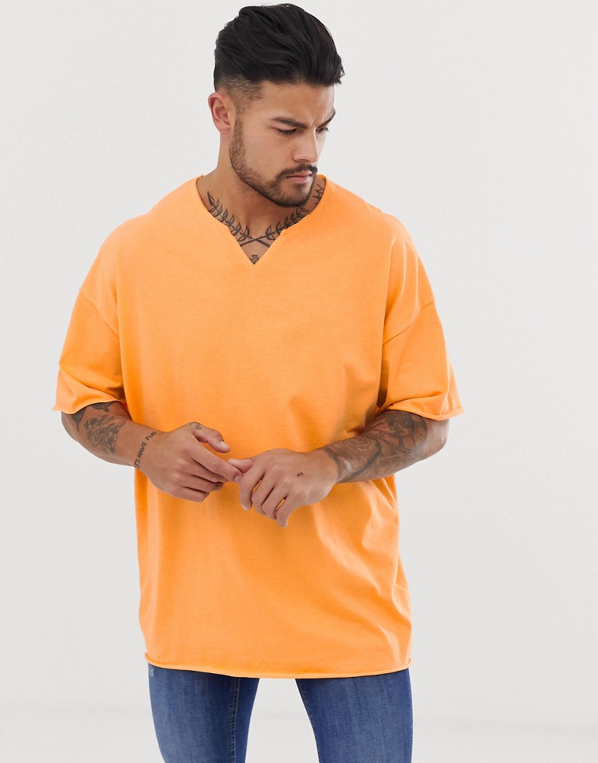 ASOS DESIGN oversized t-shirt with raw notch neck in orange