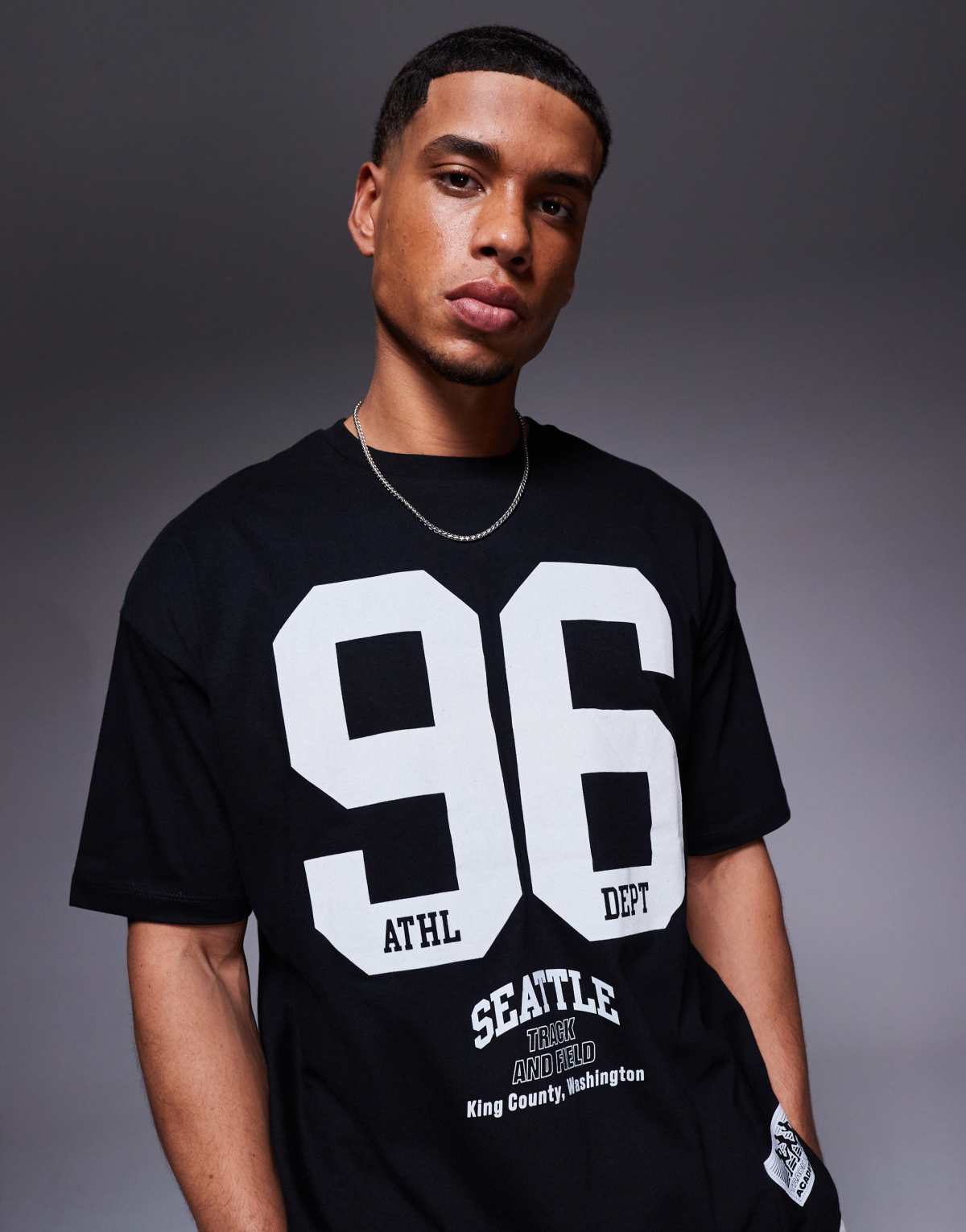 ASOS DESIGN oversized t-shirt with sports graphics in black
