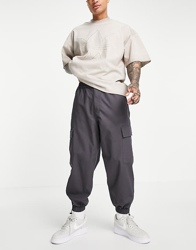 ASOS DESIGN oversized tapered cargo pants with toggle hem in gray | ASOS