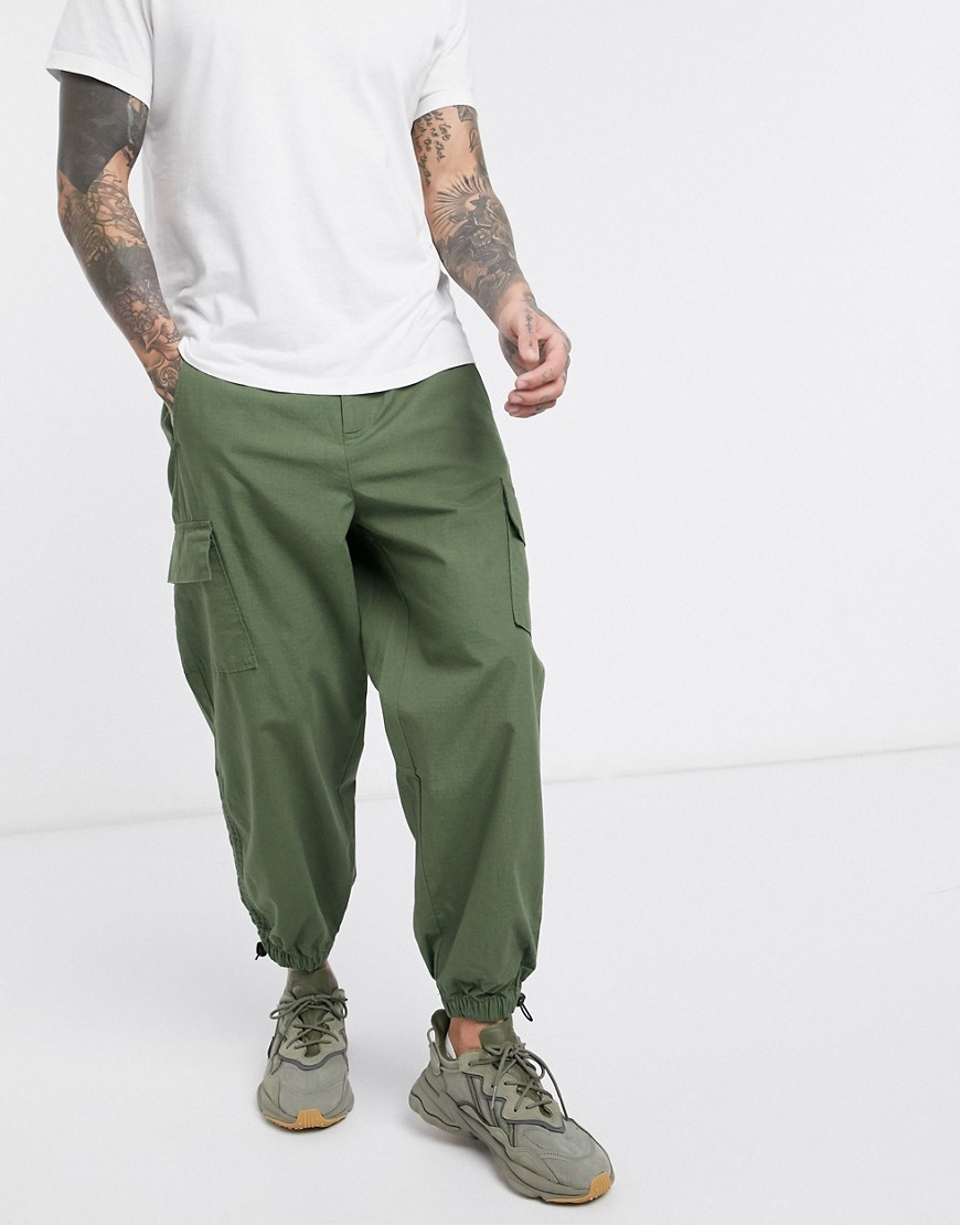 ASOS DESIGN oversized tapered cargo trousers with toggle hem in khaki ripstop-Green