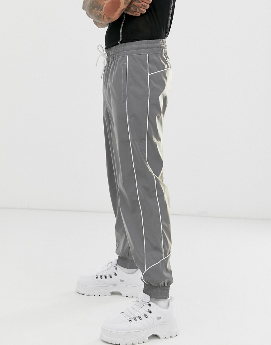 ASOS DESIGN oversized tapered joggers in reflective fabric with piping-Silver