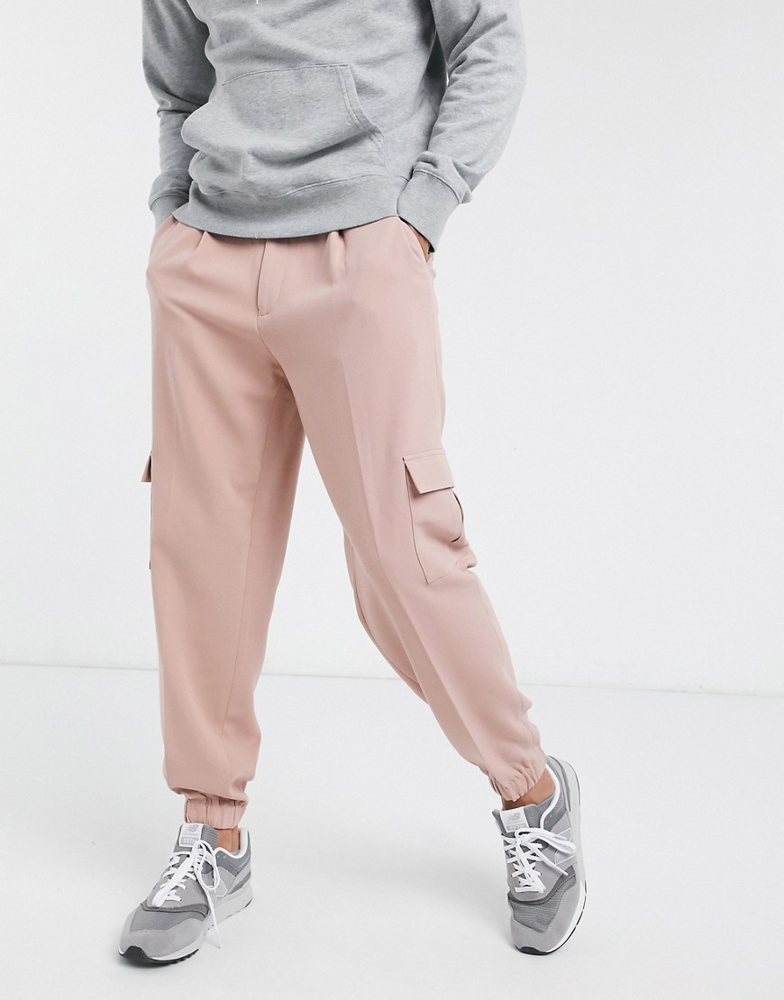 ASOS DESIGN oversized tapered smart sweatpants in pink with cargo pocket