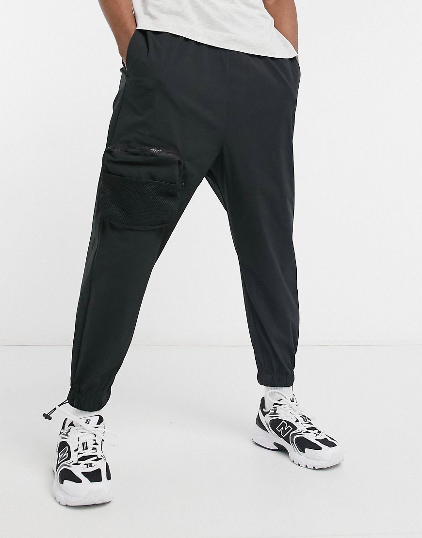 ASOS DESIGN oversized tapered sweatpants with cargo pockets in black