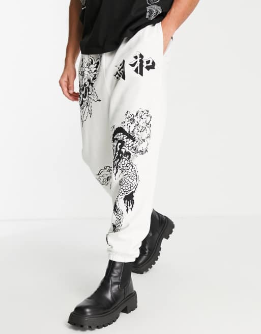 ASOS DESIGN oversized trackies in light grey with multi placement tattoo prints