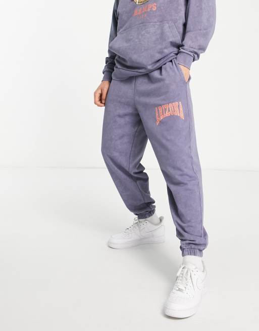 ASOS DESIGN oversized trackies in navy vintage wash with Arizona varsity print (part of a set)