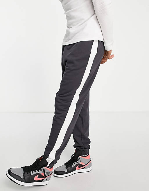ASOS DESIGN oversized trackies with side stripe in washed black | ASOS