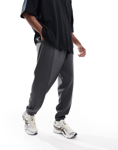 ASOS DESIGN oversized twill jersey joggers with pintucks in washed black - view 1