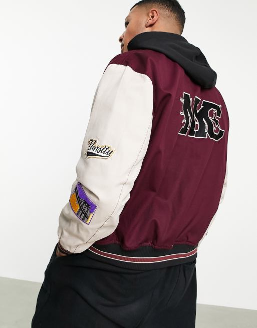 ASOS DESIGN oversized varsity bomber jacket in black with purple badging