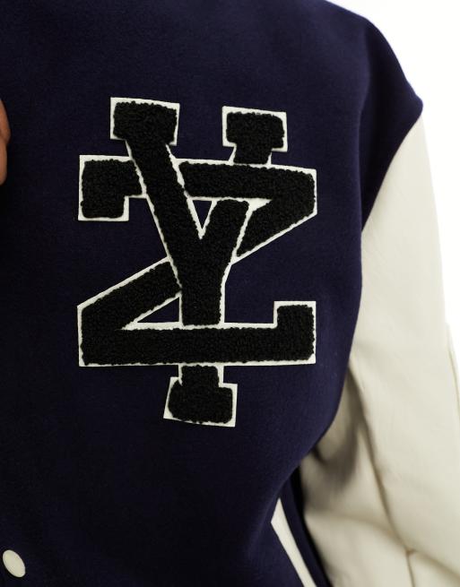 A guest is seen wearing a Louis Vuitton varsity jacket, blue and