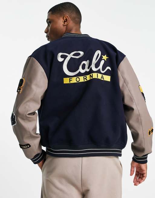 ASOS DESIGN oversized varsity jacket in navy