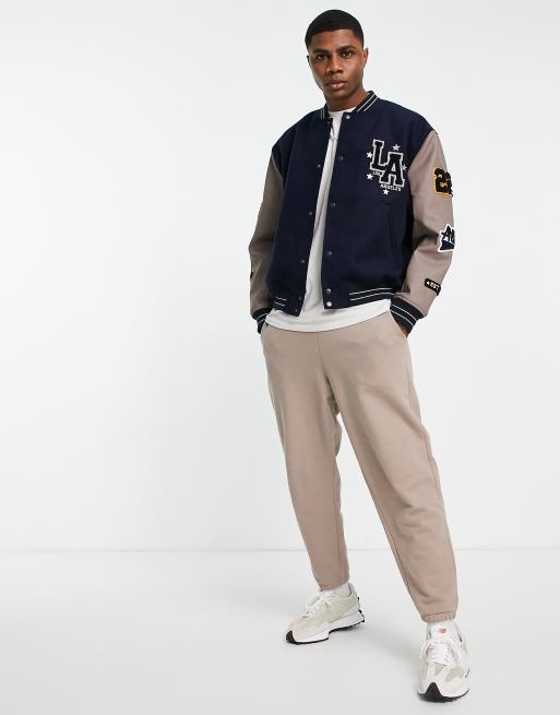 ASOS DESIGN oversized varsity bomber jacket in navy with faux leather  sleeves