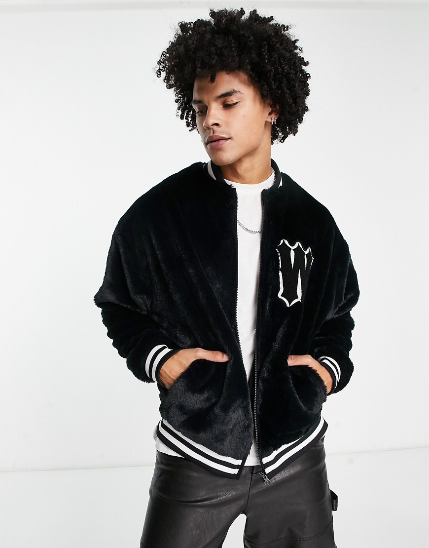 ASOS DESIGN oversized varsity faux fur jacket in black with badge and tipping