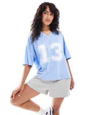 Shop ASOS DESIGN oversized varsity football shirt with graphic in blue Online – Trendy & Affordable Fashion