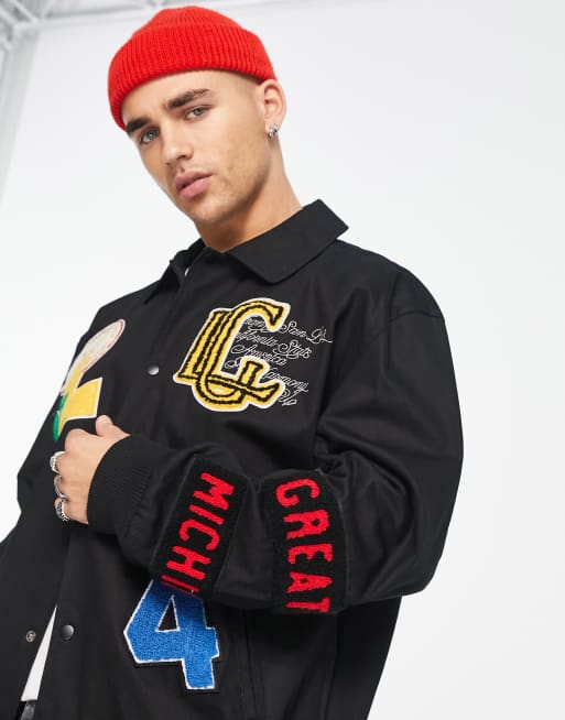 ASOS DESIGN oversized varsity jacket with badges in blue