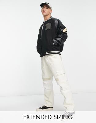 ASOS DESIGN oversized varsity jacket in black with faux leather sleeves - ASOS Price Checker