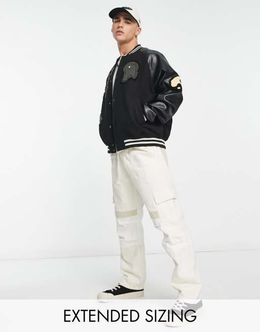 ASOS DESIGN varsity jacket in black with faux leather sleeves