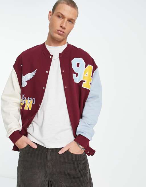 ASOS Design Oversized Varsity Jacket with Badges in Blue