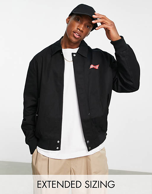 ASOS DESIGN oversized varsity jacket with Budweiser print in black | ASOS