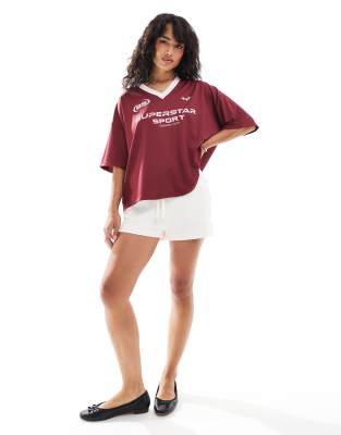 Shop ASOS DESIGN oversized varsity shirt with sports graphic in burgundy Online – Trendy & Affordable Fashion