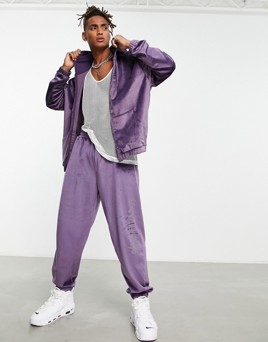 ASOS DESIGN oversized velour jogger with diamante text detail in purple