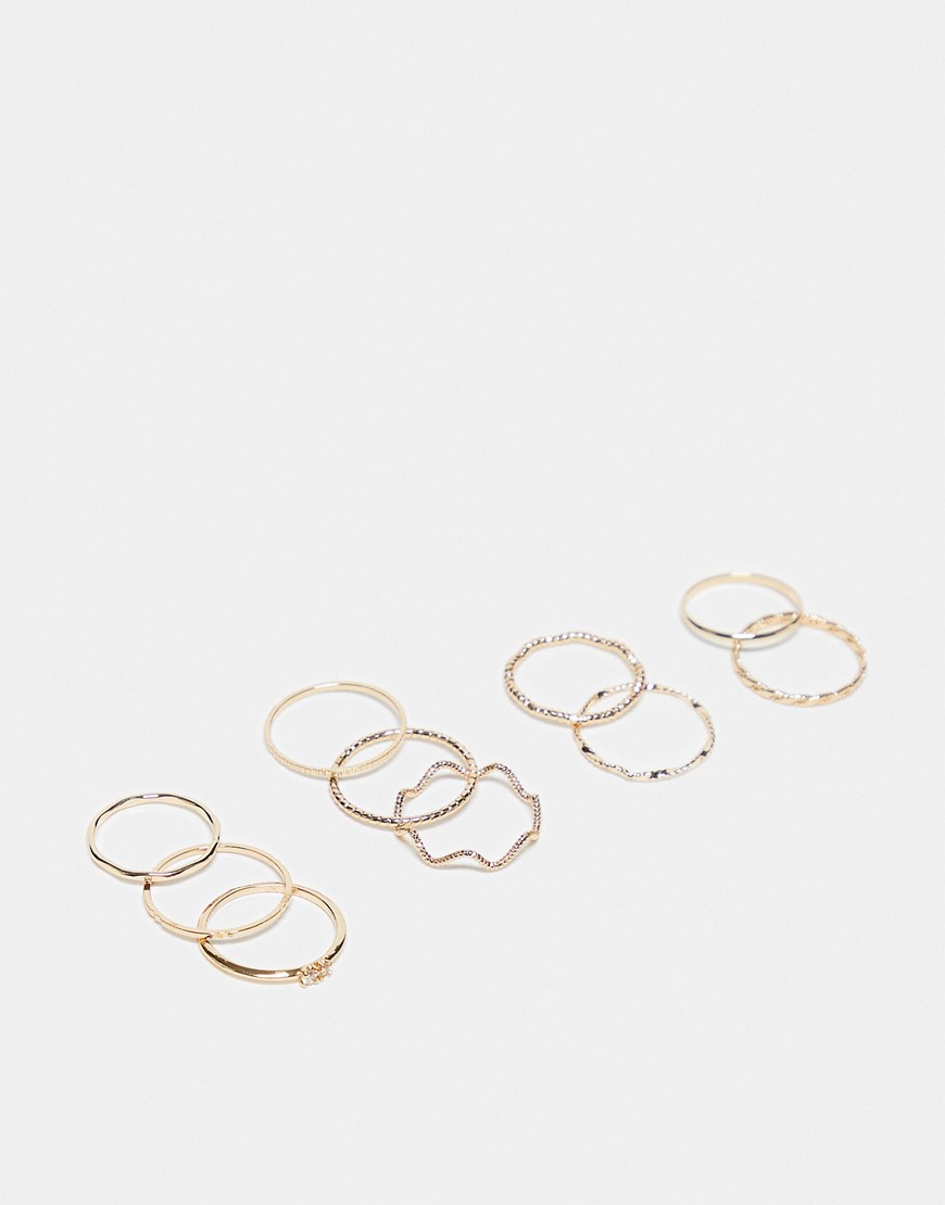 ASOS DESIGN pack of 12 rings with twist details and engraved designs in gold tone