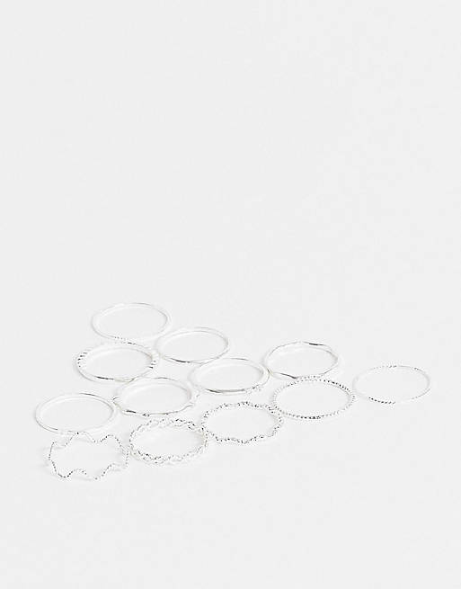 ASOS DESIGN pack of 12 rings with twist details and engraved designs in silver tone