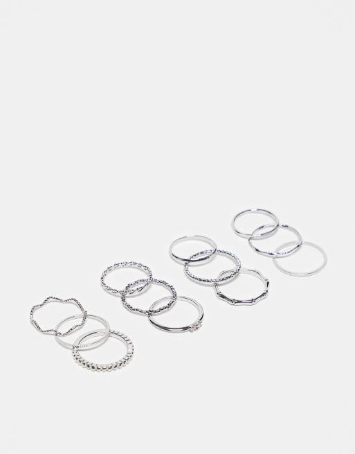  ASOS DESIGN pack of 12 rings with twist details and engraved designs in silver tone