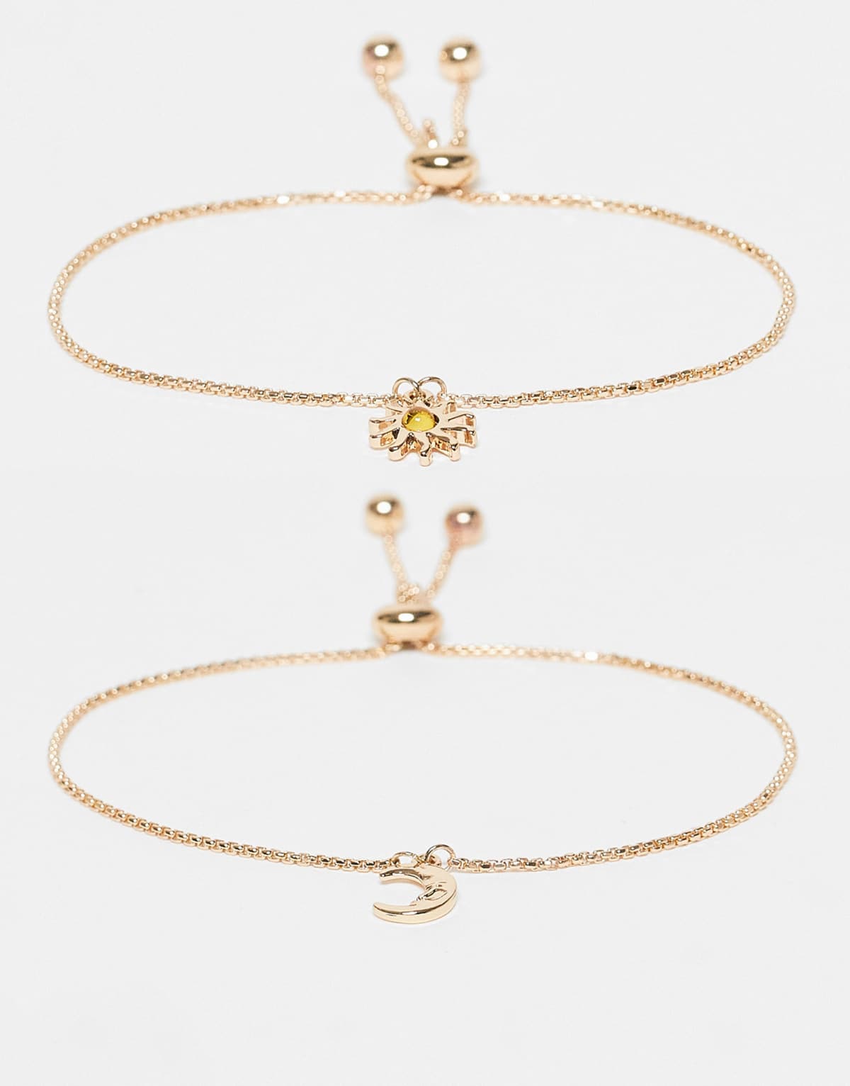 ASOS DESIGN pack of 2 bracelets with sun and moon charms in gold tone