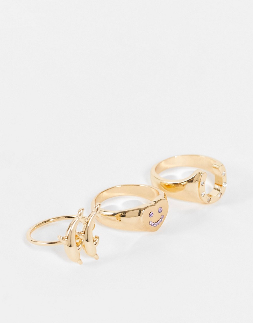 ASOS DESIGN pack of 3 rings with dolphin horse shoe and happy heart in gold tone