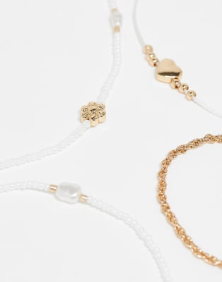 Asos Design Pack Of 4 Anklets With White Beads, Faux Pearls And Heart Charm In Gold