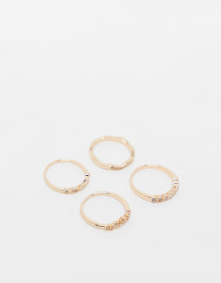 pack of 4 rings with delicate crystal detail in gold tone