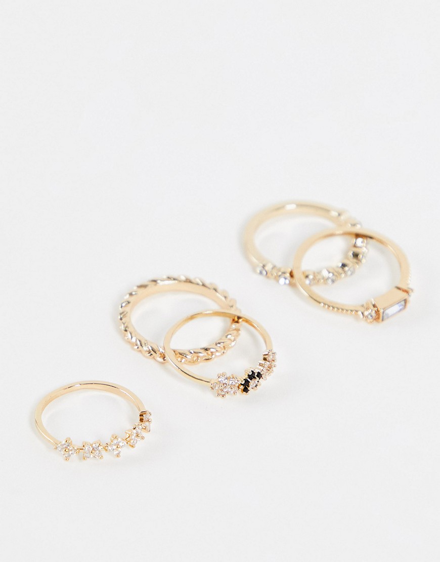 ASOS DESIGN pack of 5 rings in crystal and flower design in gold tone